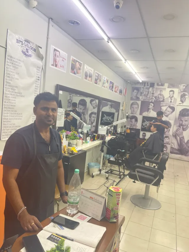 A BPS barber at the front counter of the shop