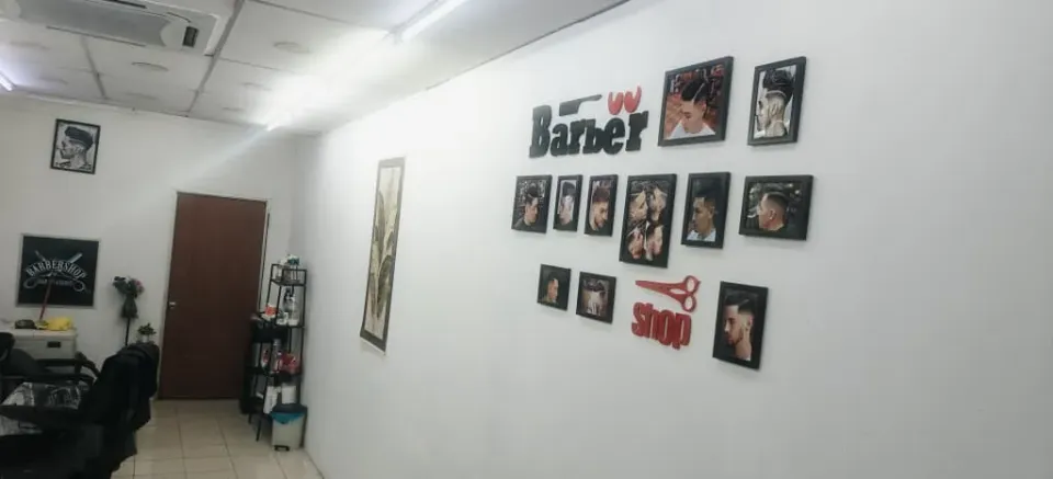 The barber shop sign and photo wall inside BPS