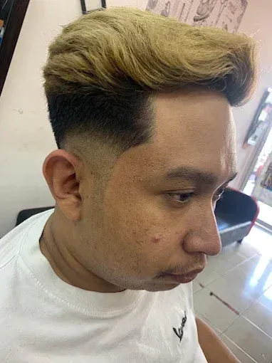 Blonde textured quiff with a fade