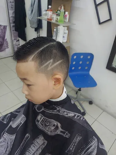 Boy's haircut with a fade and a cut-in design