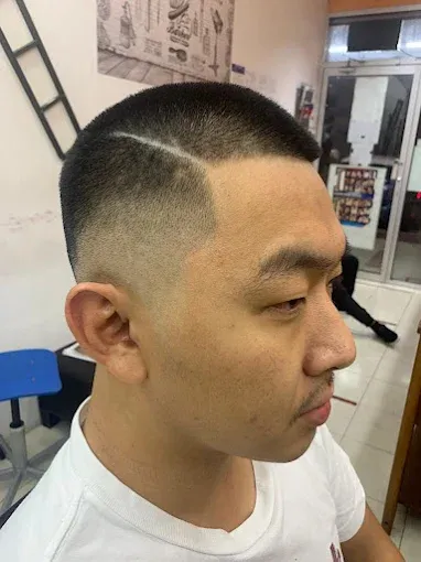 Low fade with a hard part