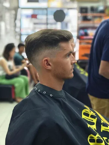 Mid fade with a textured quiff