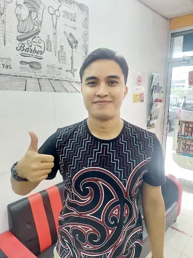 Happy customer giving a thumbs up after his cut